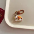 Detailed view of the cute cartoon horse keychain with a gold ingot pendant for bags and keys. - Brown Hook Style / Pony With Gold Ingot