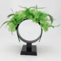 Green feather flower headband detail showing delicate petals and mesh design for parties. - Green
