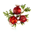Detailed close-up of exquisite red pomegranate brooch, delicate enamel leaves, vintage style. - Red Pomegranate Style (XZ4828)