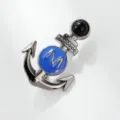 Close-up detail of a chic metal anchor brooch with blue enamel and letter M, stylish accessory. - Anchor Style (xz4509)
