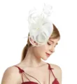 Detailed view of the elegant white feather fascinator hat, showing delicate mesh loops and texture. - White