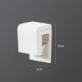 White single pack wall mounted storage clip bathroom organizer hook for daily space saving. - Wall-Mounted Toothpaste Clip