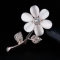 Close-up detail of the elegant cat-eye stone flower brooch with sparkling crystal leaves. - Rose Flower Style (xz4398) / Rose Gold