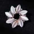 Detailed close-up of a sparkling rhinestone and cat's eye flower brooch in rose gold tone. - Flower Circle Style (xz4396)