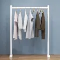 Minimalist white floor-standing clothing rack with wooden hangers for bedroom balcony use. - Length 60 Width 25 Height 120 / Pearl White