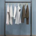 Minimalist floor-standing metal clothing rack with wooden hangers, front view for home use. - Length 60 Width 25 Height 120 / Matte Black