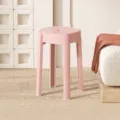 Modern minimalist pink plastic round stool, lightweight stackable home furniture for daily use. - Peach Pink