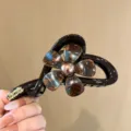 Nahaufnahme des eleganten Blumen-HaarClips mit metallic Harz-Finish für tägliches Styling. - Blumen-Haarklammer / Blau-Braun