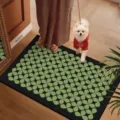 Detailed view of the black and green patterned floor mat in a cozy home setting with a pet. - Green Series-6