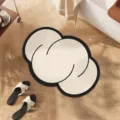 Detailed view of the abstract irregular cloud floor mat with chic black border design. - Cotton Candy Clouds