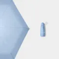 Parapluie capsule pliable en cinq parties bleu ciel, protection solaire compacte et portable. - Parapluie 5 plis avec housse en tissu / Bleu ciel