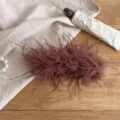 Close-up of brown feather hair claw clip, soft fluffy texture for elegant hairstyles. - Coffee Feather Banana Clip