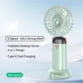 Mini ventilatore da tavolo portatile con display digitale, 5 velocità e design pieghevole. - Modello con Base di Supporto / Verde