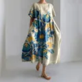 Detail view of the loose short-sleeve linen dress featuring large blue and yellow floral prints. - Large Floral Style