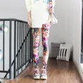 Detailed view of women colorful graffiti printed leggings, casual slim fit pencil pants style. - One Size / Bottoms / Pattern (8805)