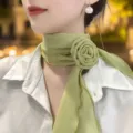 Close-up detail of the elegant light green chiffon neck scarf with a 3d rose flower design. - Rose Silk Scarf / Green