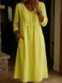 Detailed view of women's long sleeve V-neck button down linen dress with side pockets. - Yellow