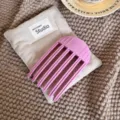 Detail shot of a purple hair root volume comb on a beige fabric pouch over a cozy textured blanket. - H61-3# 6-Teeth (Large)