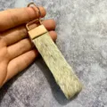 Detailed view of vintage bohemian hair-on-hide leather keychain with rose gold hardware. - Style 4