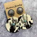 Close up of western vintage cowhide leather earrings with cactus pendant and turquoise details. - Style 1
