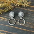 Detailed close-up shot of retro western metal earrings featuring a sunflower stud and textured drop hoop. - Sunflower Round Loop Style