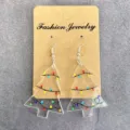 Close-up detail of clear acrylic Christmas tree earrings with colorful light print display. - Christmas Tree With Colorful Lights