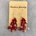 Detailed close-up shot of red and black plaid Christmas tree acrylic earrings on card. - Red and Black Plaid Snowflake Christmas Tree
