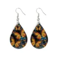 Closeup of teardrop wooden earrings featuring monarch butterfly and wave print, lightweight. - Butterfly Wave (15)