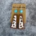 Close-up detail of retro wooden leopard print cowhide earrings with turquoise beads and hooks. - Leopard Patchwork Wood Style(2)
