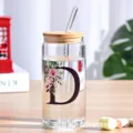 Clear glass can cup with bamboo lid and straw, floral letter D design for cold drinks juice. - Style D