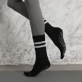 Professional yoga five-toe grip socks with anti-slip soles and mid-calf breathable design. - Black