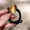 Elegant black hair tie with metallic gold heart ornament, chic ponytail holder fashion accessory. - Heart Hair Tie (A6-3)