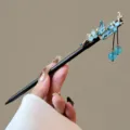 Detailed close-up of the vintage Chinese wooden hairpin featuring blue crystal flower and tassel. - Shulianyu Style (FZ25111)