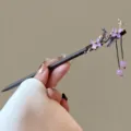 Detailed view of traditional Chinese wooden hair stick with floral design and elegant tassels. - Feiyeying Style (FZ25112)