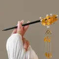 Handmade Chinese style floral hair stick with delicate amber petals and long gold tassels. - Koi Orange Yellow