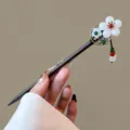 Close-up detail of vintage wooden hairpin with plum blossom jade decor and tassel beads. - Shanquansan Style (FZ25119)