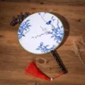 Traditional Chinese round fan with blue and white floral bird pattern, black handle and tassel. - Purple Peony and Bird