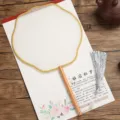 Traditional Chinese round fan with wooden handle and silver tassel for DIY painting art craft. - Beechwood Lanterns with Yellow Border