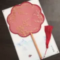 Traditional Chinese round hand fan with gold floral embroidery, wooden handle and red tassel. - Eight-Petal Beech Handle - Red Small Floral