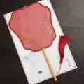 Traditional Chinese round fan with gold floral stamping, wooden handle and red tassel. - Feixian Beech Wood - Red Small Floral