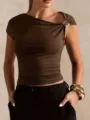 Closeup view of women asymmetric off shoulder brown crop top with elegant gold buckle detail. - S / Coffee