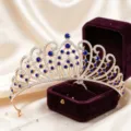 Exquisite gold bridal tiara with sparkling rhinestones and blue crystals, detail display. - KC Gold + Blue Rhinestone