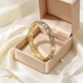 Bracciale rigido placcato oro con smalto viola e strass floreale in confezione. - Viola + Viola