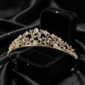 Detailed view of the luxury gold crystal tiara princess crown headband for party wear. - Gold