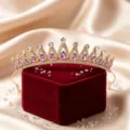 Exquisite gold bridal tiara with purple rhinestones on a red velvet box, detailed view. - KC Gold - Purple
