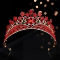 Detailed close-up shot of a luxury red rhinestone bridal tiara baroque crown for stunning wedding. - Gold + Red Rhinestone