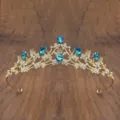 Detailed close-up of golden crystal tiara with blue teardrop rhinestones for kids performance. - Gold with Lake Blue