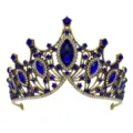 Close-up detail of vintage baroque gold crown with deep blue gemstones and clear rhinestones. - Antique Gold Blue Rhinestone