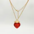 Gold chain necklace close-up, featuring a red crystal heart pendant with a golden crown detail. - Cross Chain Necklace Only (Without Tiara)