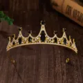 Gold crown tiara detail featuring black and clear rhinestones on dark wood background. - Gold + Black Rhinestone